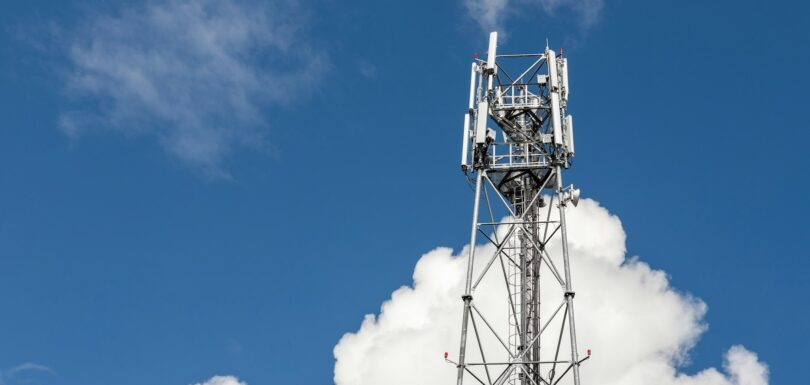 Bottom perspective pov of modern metal steel mobile 5g network wireless telecom tower against clear